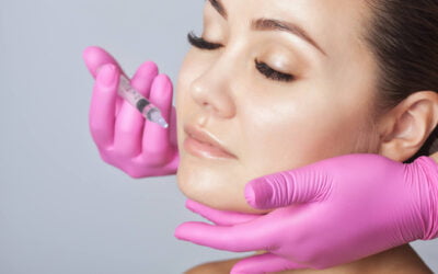 A certified cosmetic surgeon doing lip augmentation to a patient in Newport Beach, California at Dr. George Brennan's clinic