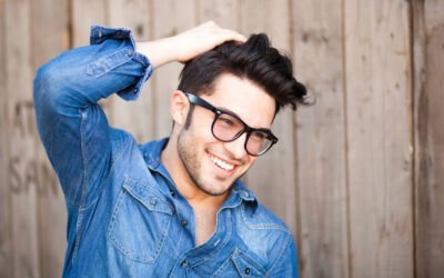 A patient smiling after a neograft hair transplant in Newport Beach, California at Dr. George Brennan's clinic